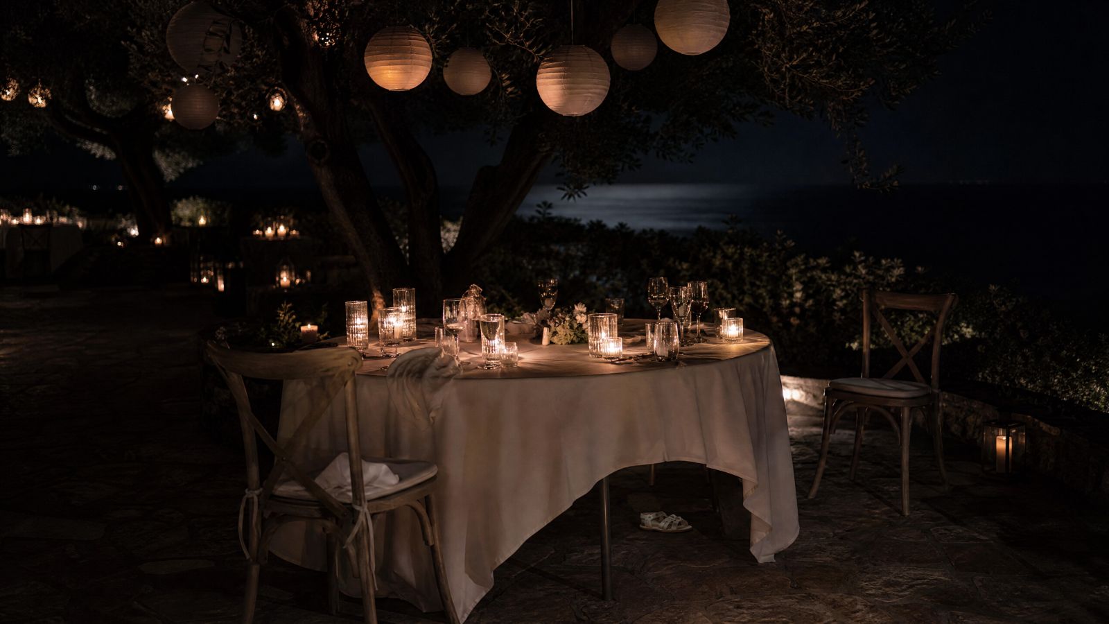 The lantern garden past midnight, most of the lanterns out and the table left as it was.