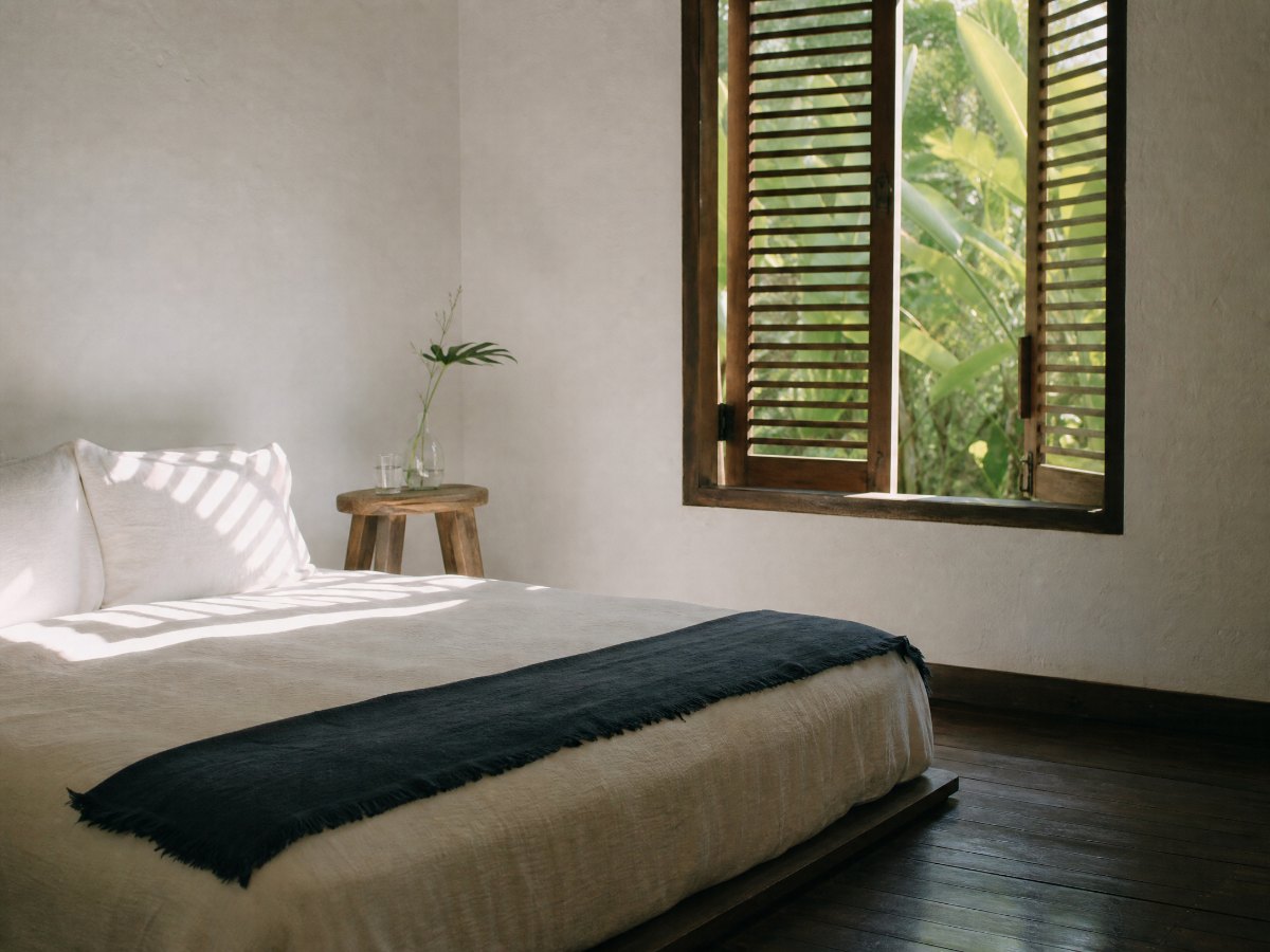 A guest room at Casa Marikit, shutters open onto the garden.