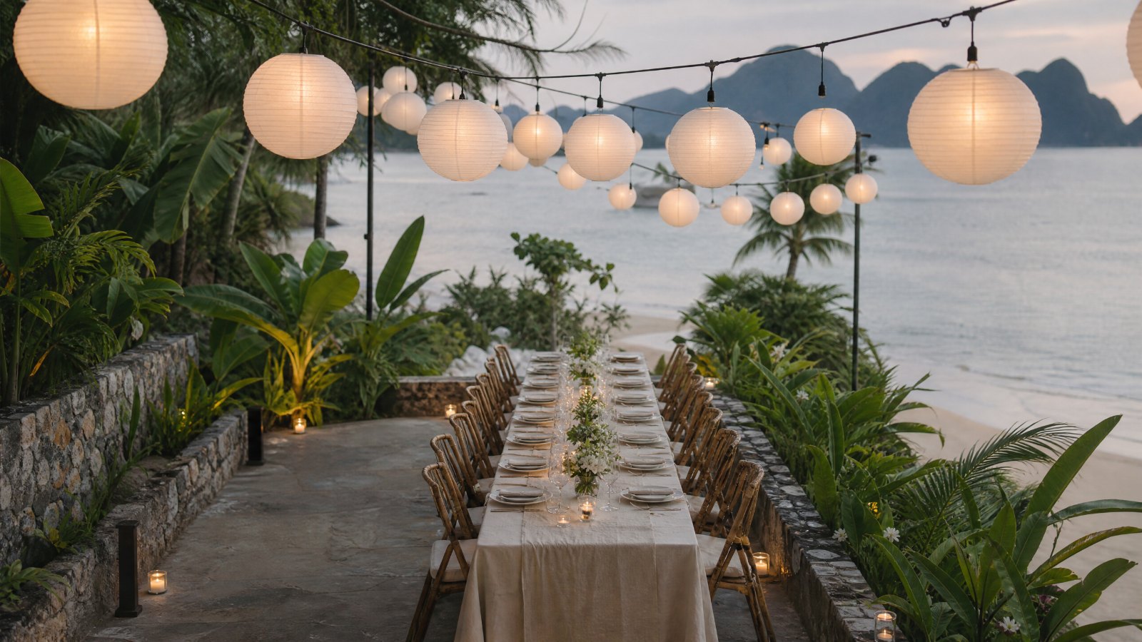 The garden terrace at Casa Marikit in daylight, plain paper lanterns strung between the trees.