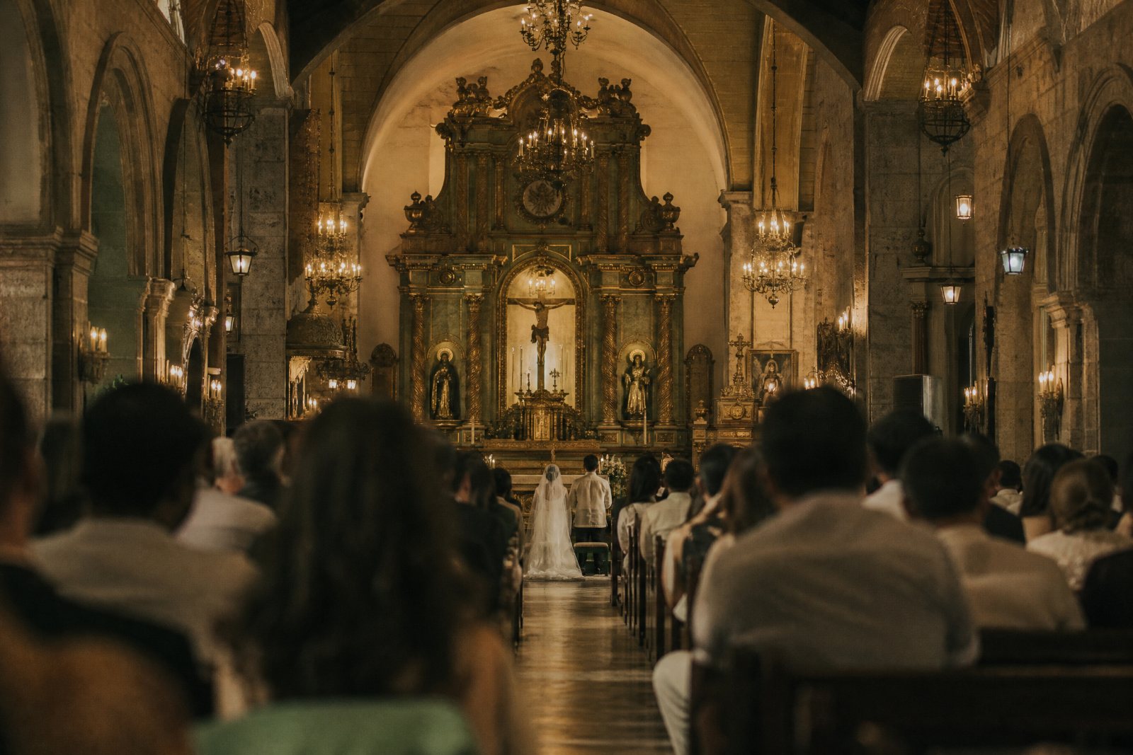 Andrea and Paolo at the altar, photographed from behind the congregation.
