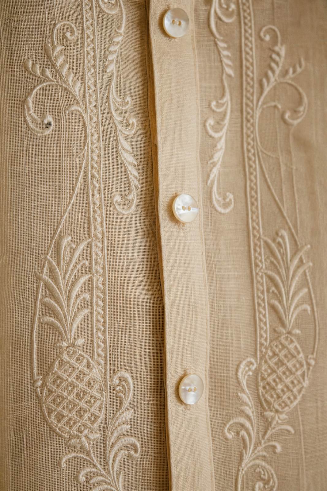 Close detail of embroidered pi&ntilde;a fabric on a barong.