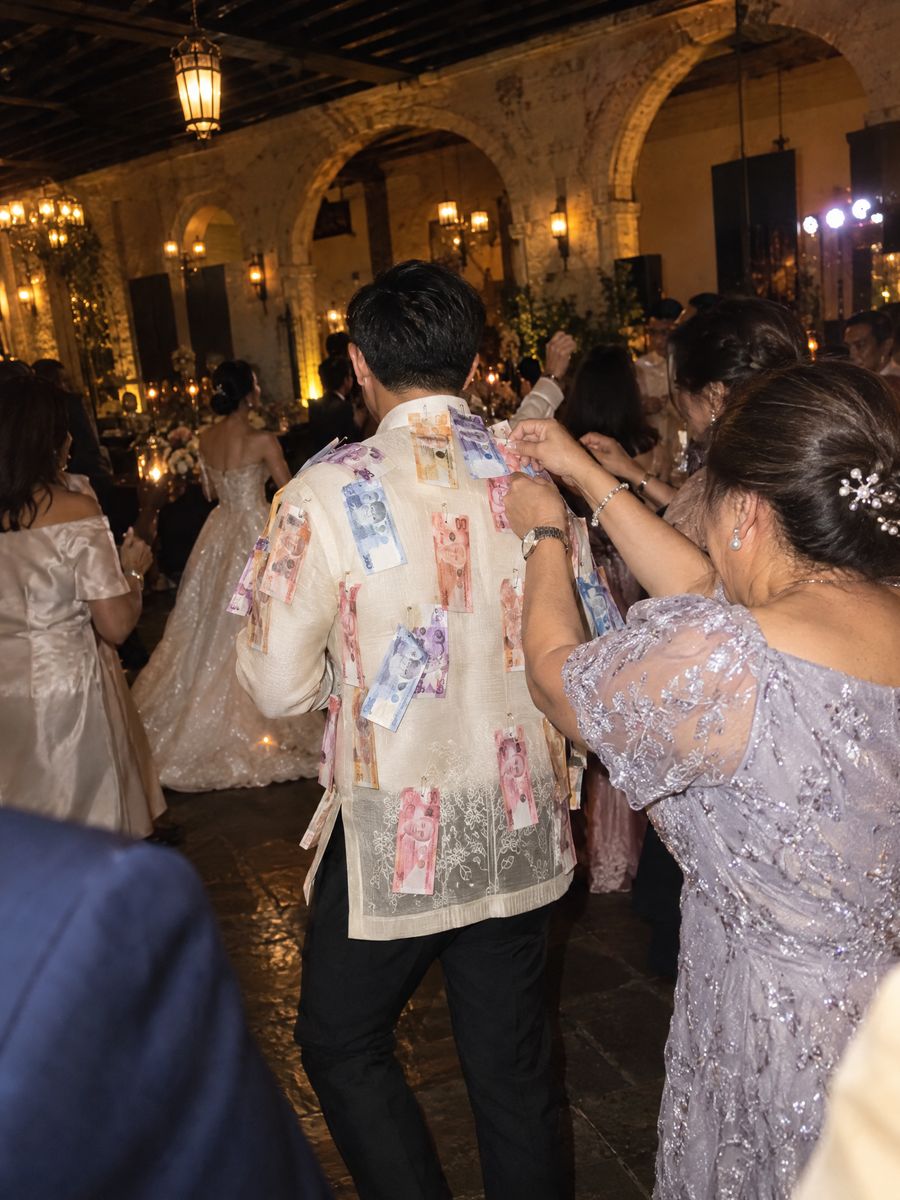 Peso bills pinned to the back of Paolo’s barong during the money dance.